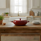 Red casserole dish on a wooden kitchen counter with a white kitchen background